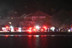 Lights from emergency vehicles are seen as rescue crews gather along the Potomac River near Reagan National Airport in Washington, DC, after an air crash on January 29, 2025. A passenger jet from Kansas crashed into Washington's Potomac River after colliding mid-air with a military helicopter near Reagan National Airport, officials said Wednesday, prompting a major emergency response and grounding all flights. (Photo by ANDREW CABALLERO-REYNOLDS / AFP) (Photo by ANDREW CABALLERO-REYNOLDS/AFP via Getty Images)