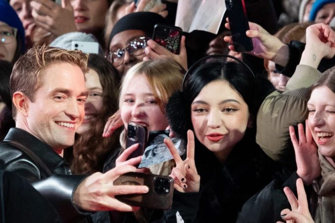 BERLIN, GERMANY - FEBRUARY 15: Robert Pattinson reacts with fans as attends the "Mickey 17" premiere during the 75th Berlinale International Film Festival Berlin at Berlinale Palast on February 15, 2025 in Berlin, Germany.  (Photo by Andreas Rentz/Getty Images)