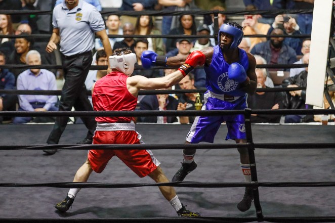 Abimbola "Abel" Osundairo (in blue) in the ring during the senior novice light heavyweight division final boxing match against John Broderick