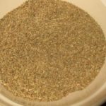 ajwain seeds in a beige ceramic bowl