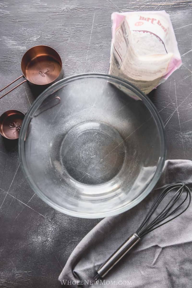 ingredients for making egg replacer powder with glass bowl and whisk