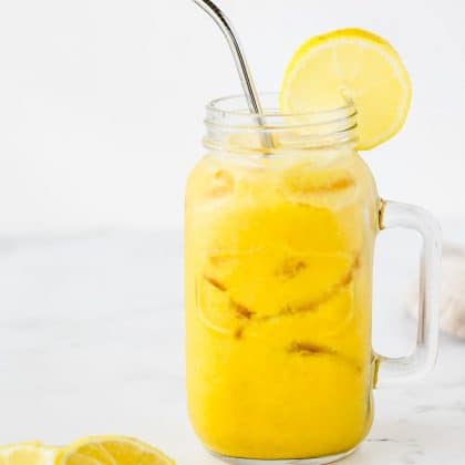 singing canary in mason jar with garnish of lemon and metal straw