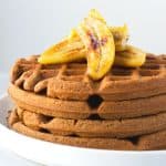 teff waffles topped with banana slices