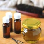 bottles and a jar of essential oil blend for hair growth