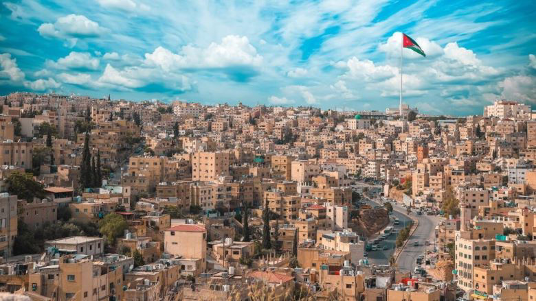 Scenic shot of the city of Amman with the Jordan flag in Jordan. 