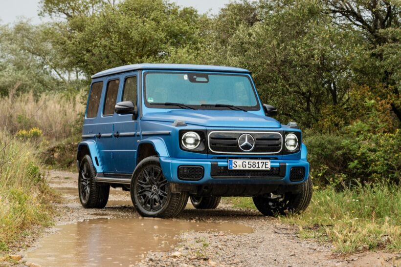 Blue 2025 Mercedes Benz G 580 EQ electric SUV on a muddy road