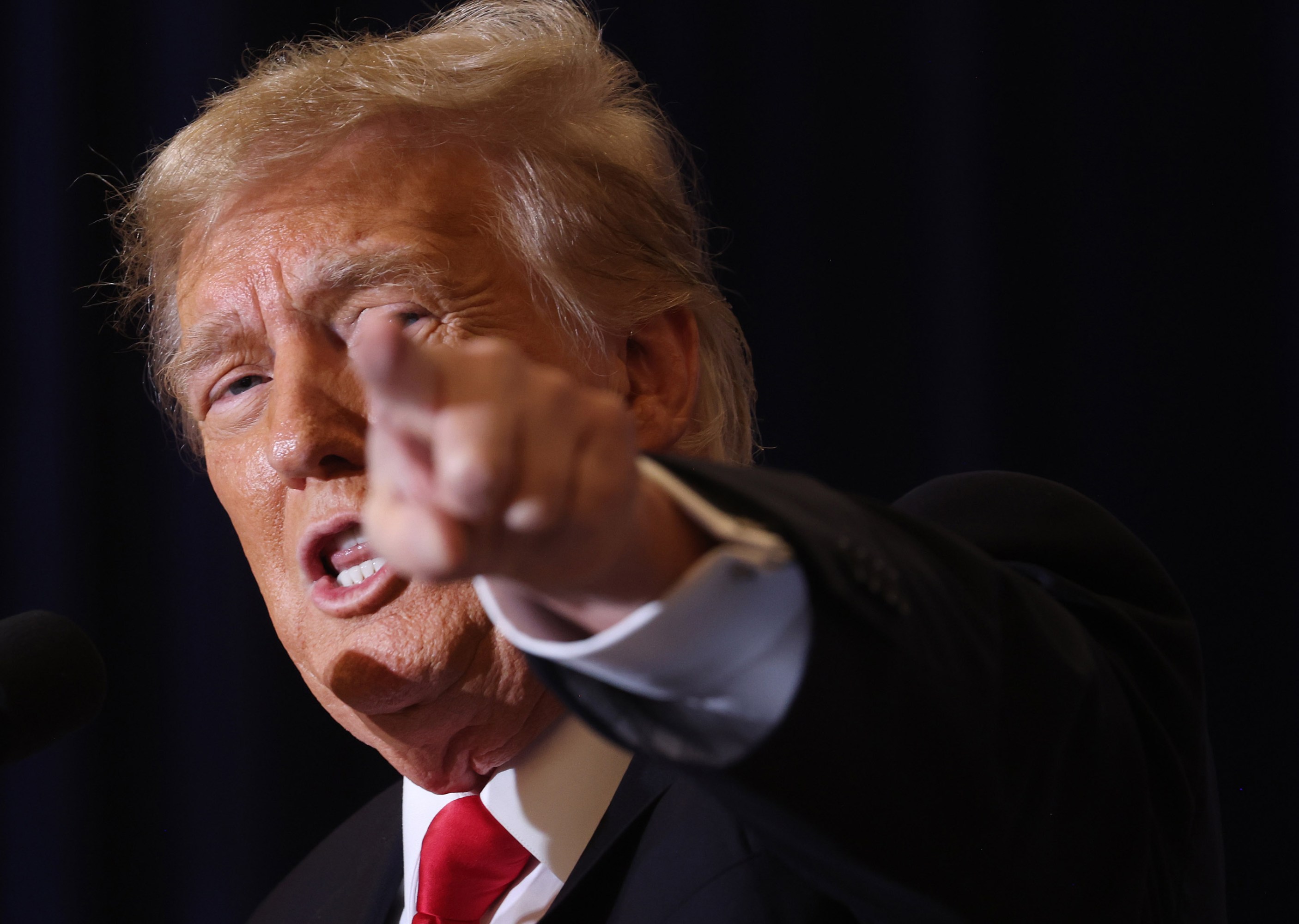 Close up of former President Trump pointing directly at camera while speaking at a campaign event in Iowa