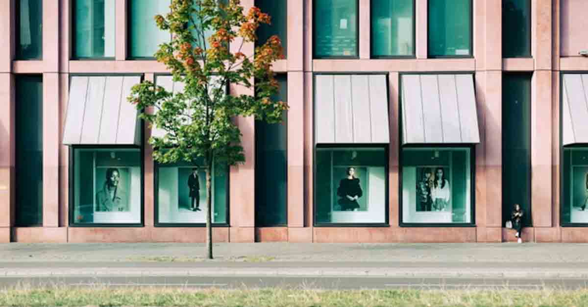 Image of a retail storefront with display windows on a main street, showcasing an ideal site for retail business.