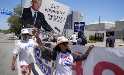 Supporters of Presidential candidate Robert F. Kennedy Jr. protest outside the Warner Bros. Studios in Burbank, Calif., Friday, June 21, 2024. (AP Photo/Damian Dovarganes)