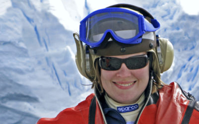 A person wearing sunglasses taking a selfie in the snow.