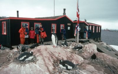 Visitors to the Antarctic Heritage site of Port Lockroy on the Antarctic Peninsula. Port Lockroy was established in 1944 is the only surviving base from Operation Tabarin and is one of the most visited tourist sites in Antarctica.