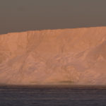 A close up of a snow covered mountain.