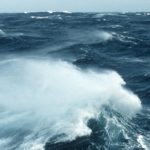 A man riding a wave in the ocean.