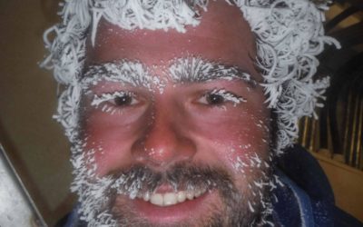 A close up of a man wearing a hat.