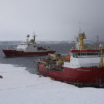 Two large ships at an icy coastline