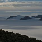 A group of people standing on top of a mountain.