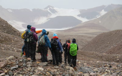 A group of people standing on top of a mountain.