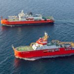 Two large red research ships in the ocean