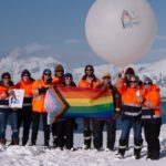 A group of people standing in the snow