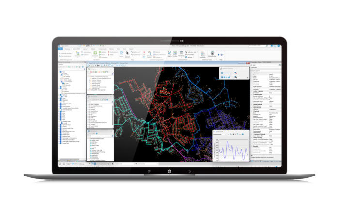 A laptop screen displaying complex software interface with maps, charts, and various data analysis tools. The background features a detailed map with colorful lines and nodes.