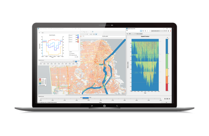 A laptop displaying a geographic information system (GIS) interface with maps, graphs, and data visualizations.