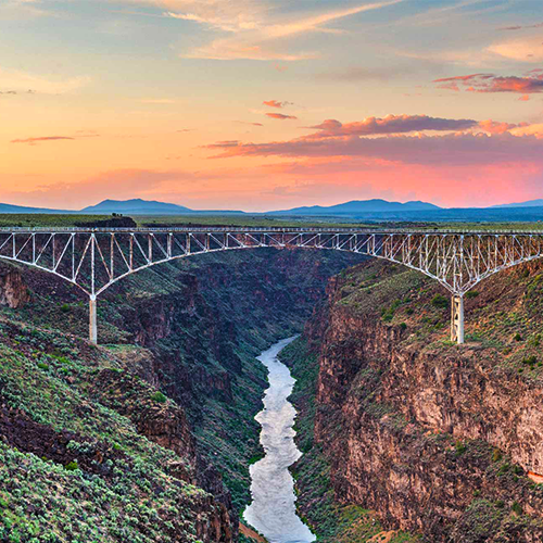 bridge across gorge and river at sunset