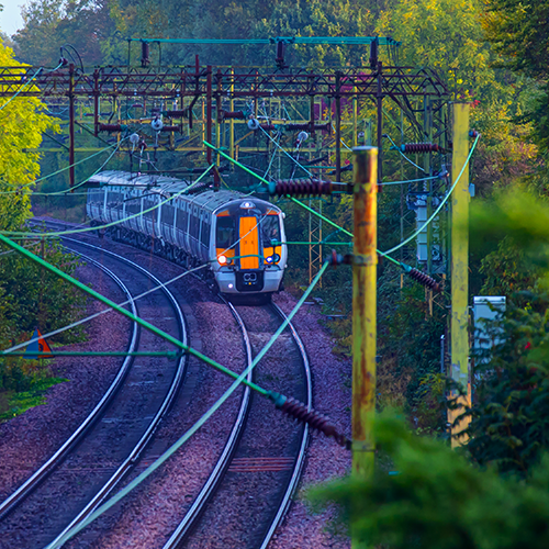 A green border with a train on the tracks.