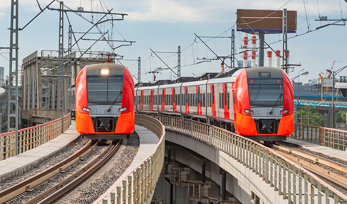 red metro trains coming towards you running on rail tracks