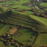 Glastonbury Tor rises above the low-lying wetlands of the Somerset Levels, one of the sample areas for the new research. BGS © UKRI.