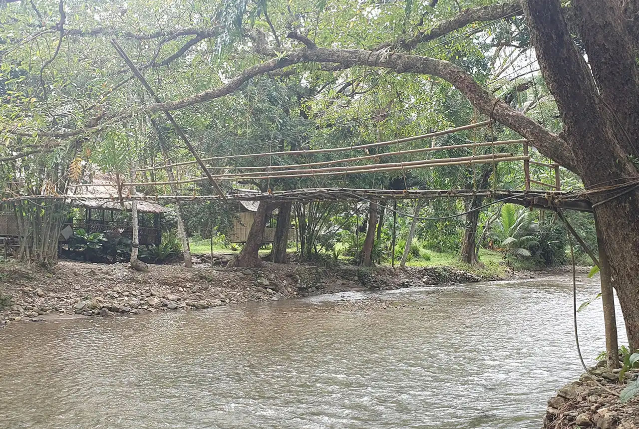 A wooden bridge crosses the Naboay river, Panay Philippines. Andrew Barkwith, BGS © UKRI.