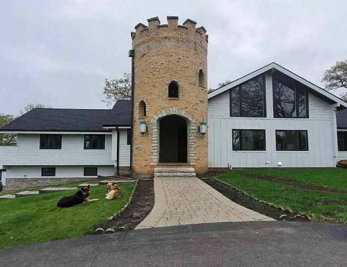 Unusual home design with a brick turret entrance juxtaposed against modern house architecture.