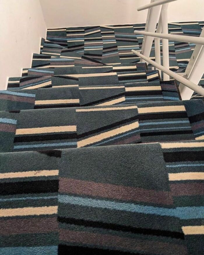 Carpet design disaster on a staircase with misaligned geometric patterns causing visual confusion.