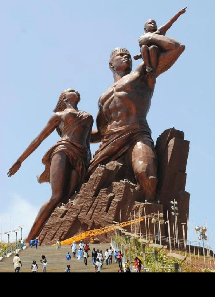 Massive statue of a family, with people walking up the steps, showcasing megaphobia-inducing proportions.