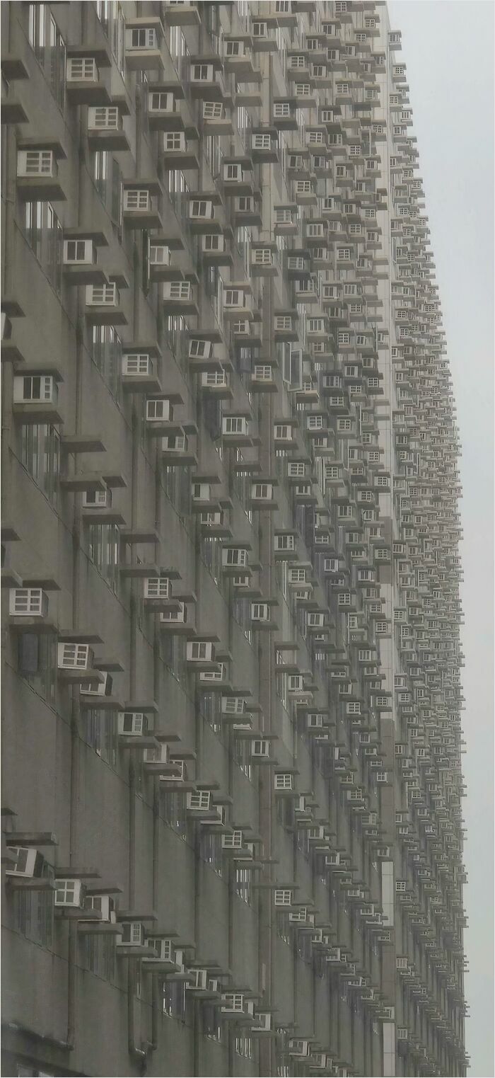 Rows of air conditioners on a massive building, a sight that could trigger megalophobia.