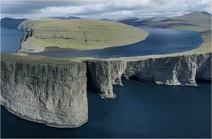 Aerial view of colossal cliffs and vast sea, perfect for triggering megalophobia.