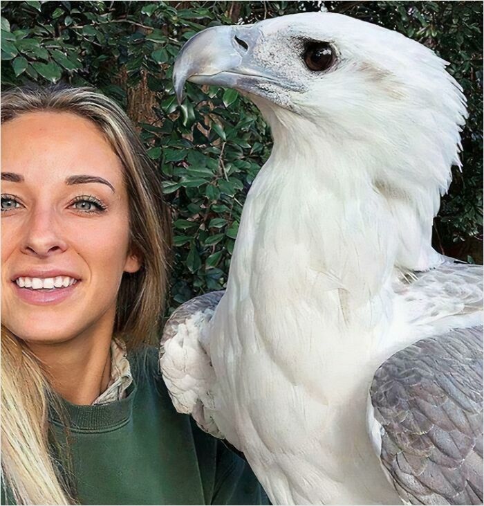 Woman beside a gigantic bird, showcasing a fearsome size perfect for anyone with megalophobia.