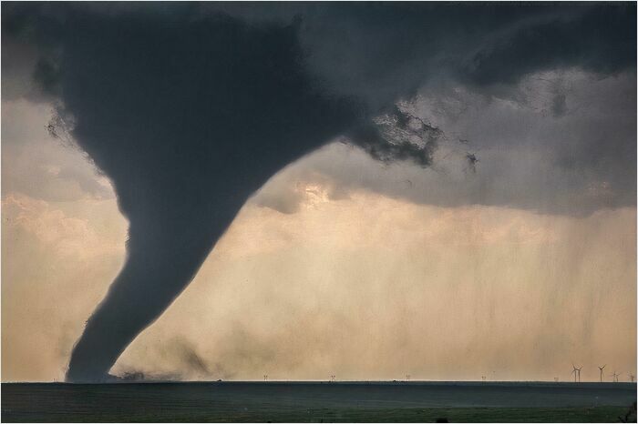 Massive tornado touching down on open landscape, a striking sight for those with megalophobia.