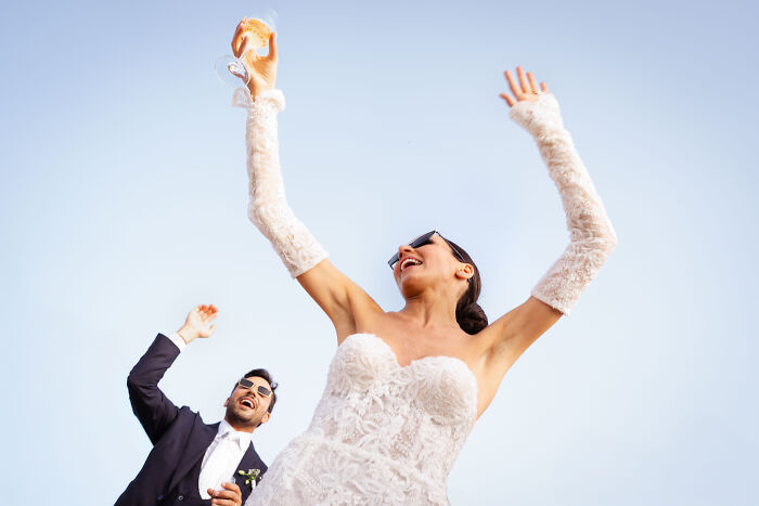 Bride and groom celebrating outdoors, capturing joyful moments from top 2024 wedding photos.