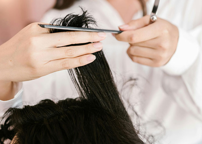 Close-up of a DIY haircut, illustrating creative frugal hacks to save money.