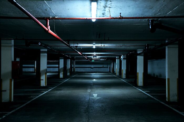 Dimly lit underground parking, associated with behind-the-scenes activities in casinos.