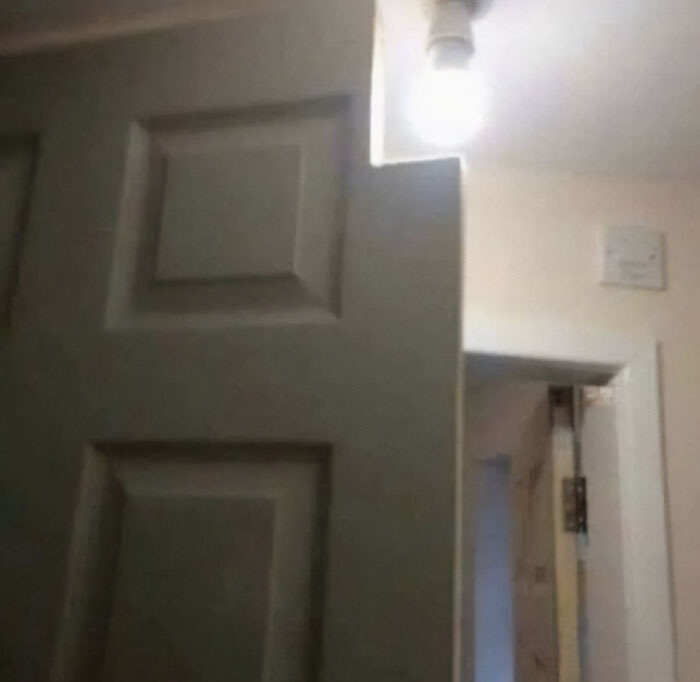 Poorly designed door cut around a ceiling light, a clear design disaster deserving to be shamed.