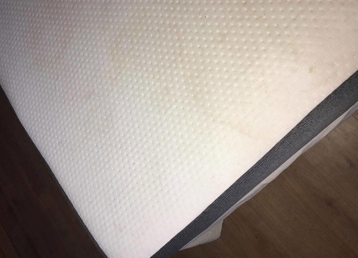 Mattress placed sideways on floor, illustrating using things the wrong way.