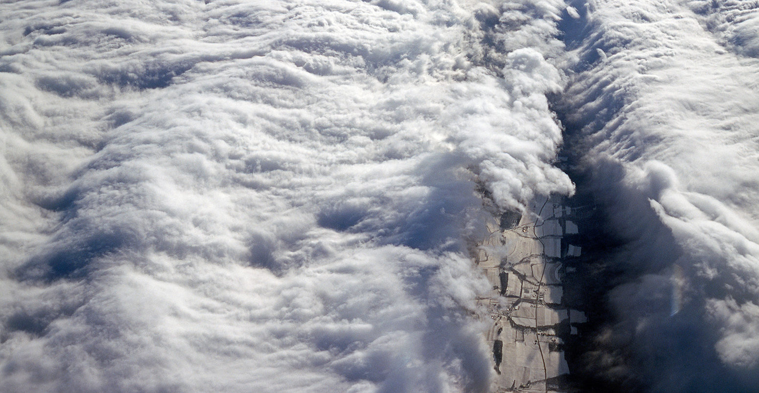 B6P8JD Aerial view of dramatic white clouds against a blue sky