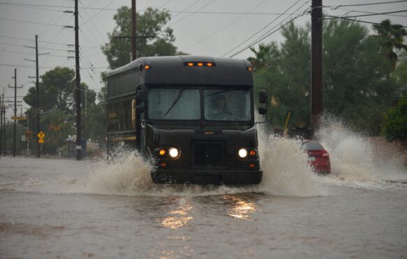 A delivery truck driving through flooded streets during a storm, Sonoran Desert, Arizona, USA. Credit: Norma Jean Gargasz / Alamy Stock Photo. Image ID: H28H7P