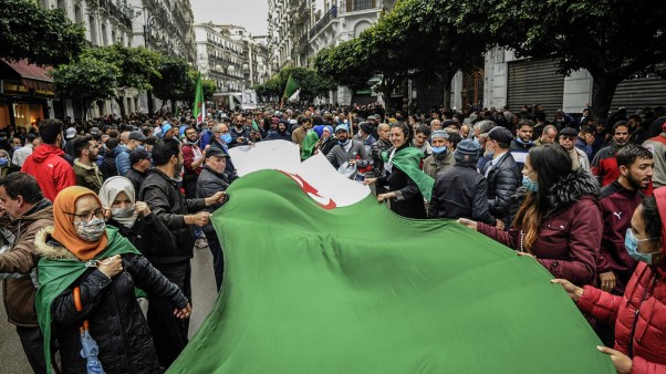 People in Algiers wave a big Algerian flag during a protest held today to mark the second anniversary of the mass demonstrations, commonly known as the Hirak Movement, that pushed long-time ruler Abdelaziz Bouteflika out of office in April 2019.