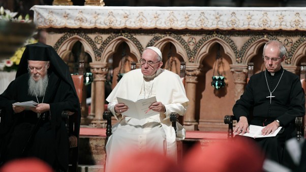 In this 2016 file photo, Pope Francis flanked by Orthodox Patriarch of Constantinople Bartholomew I, left, and Canterbury Archbishop Justin Welby, pray together inside the Basilica of St. Francis, in Assisi, Italy.