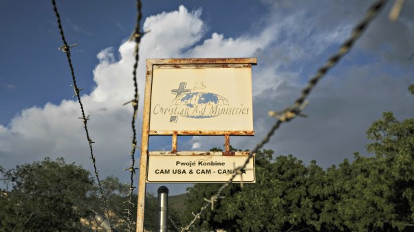 This Oct. 21, 2021, photo shows a sign outside Christian Aid Ministries in Titanyen, Haiti, which had 17 of their members kidnapped by the 400 Mawozo gang. Catholic priest Jean-Nicaisse Milien was kidnapped for 20 days along with other priests, nuns, and civilians in April by same gang.