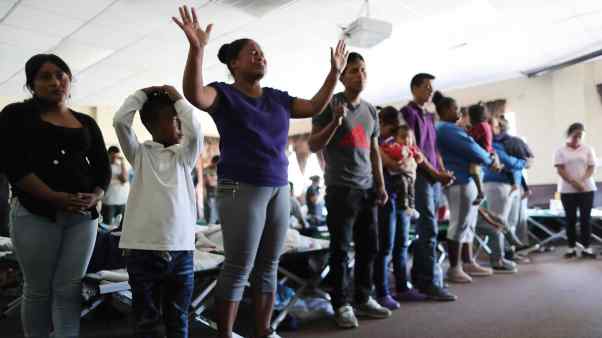 Migrants arriving in El Paso, Texas, attend a worship service at a church shelter.