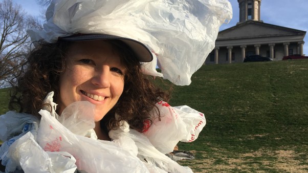 Sadie McElrath dresses as a "plastic bag monster" to talk to state legislators about trash.