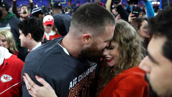 Travis Kelce of the Kansas City Chiefs celebrates with Taylor Swift after a victory against the Baltimore Ravens.